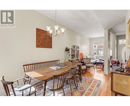 A dining room with a wooden table and chairs.