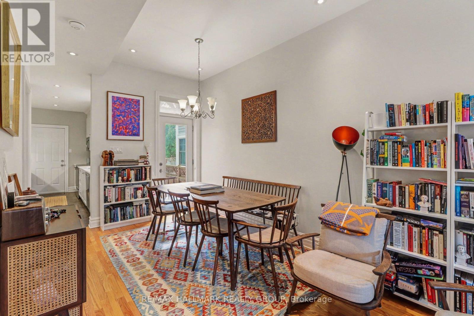 A living room with a bookshelf filled with books.
