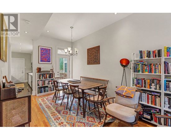 A living room with a bookshelf filled with books.