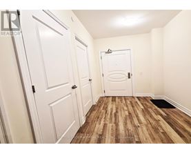 A hallway with white doors and a wooden floor.