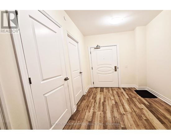 A hallway with white doors and a wooden floor.