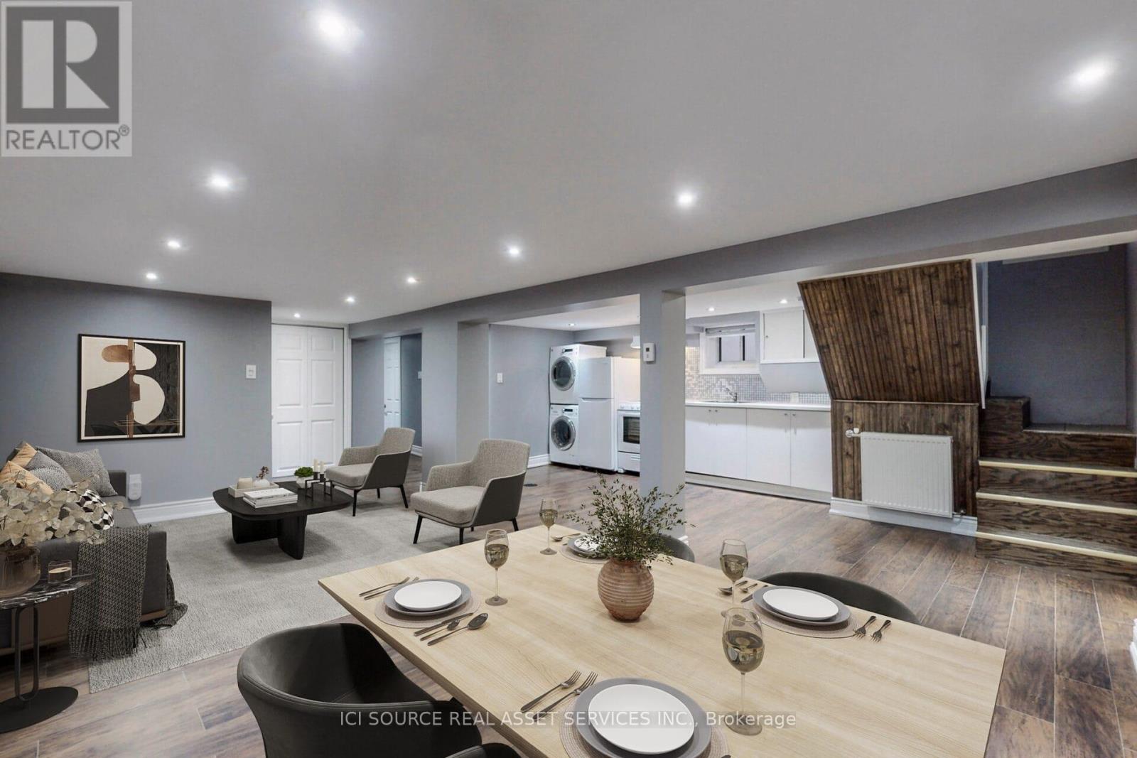 A modern dining room with a wooden table set for two.