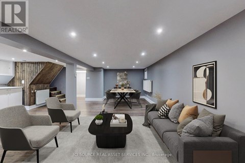 A modern living room with a grey sofa, a coffee table, and a dining table with chairs.