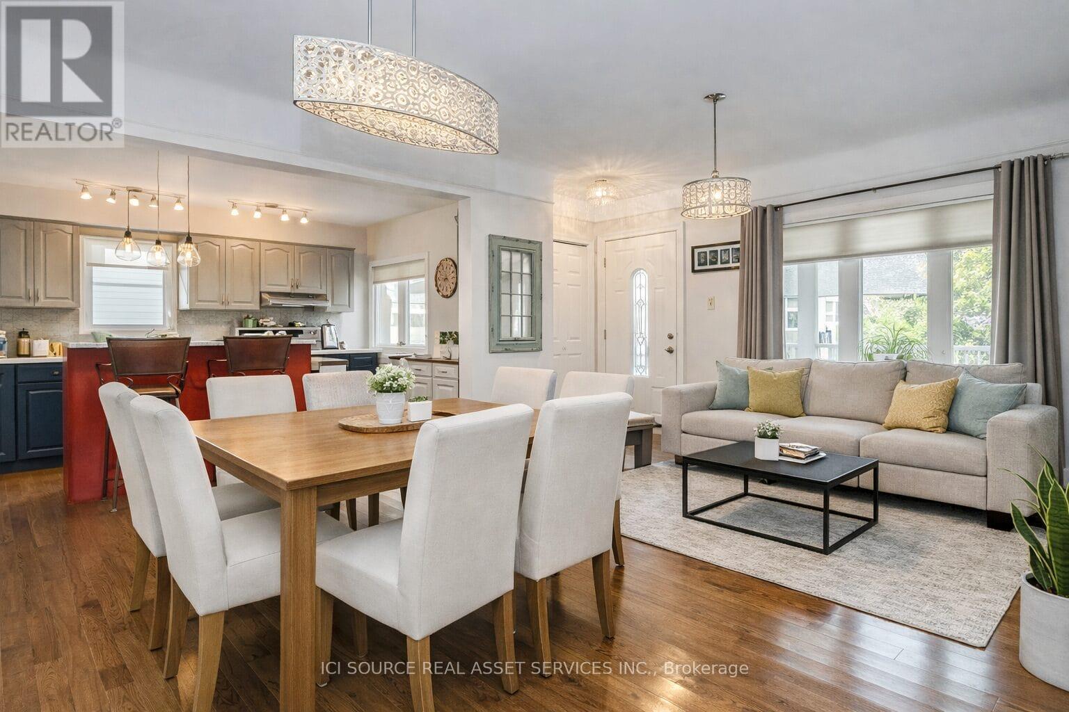 A well-lit, modern dining room with a wooden table and chairs.