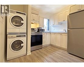 A clean, modern kitchen with a washer and dryer built in.