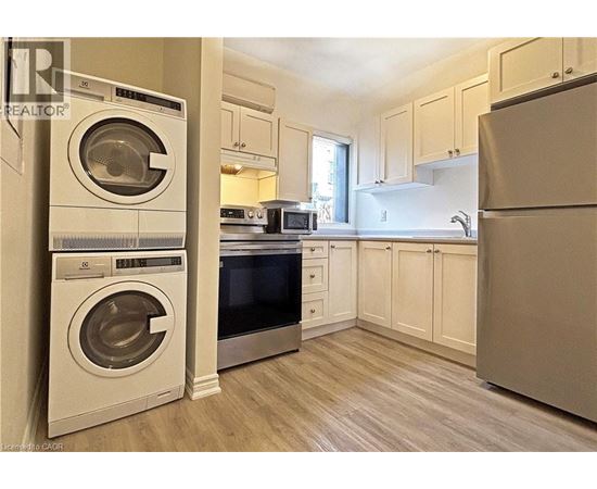 A clean, modern kitchen with a washer and dryer built in.