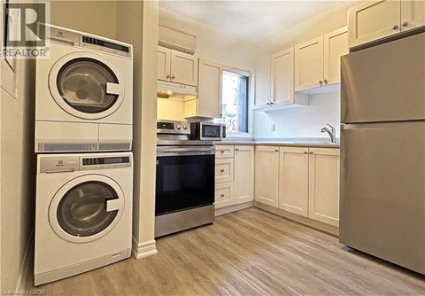 A clean, modern kitchen with a washer and dryer built in.
