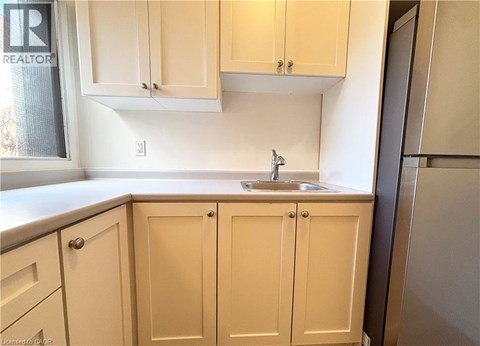 A kitchen with a sink and cabinets.