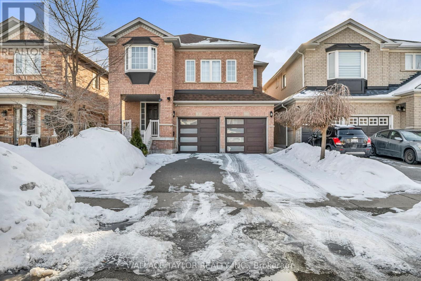 A house with a driveway covered in snow.
