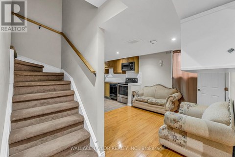 A living room with a couch and a television set.