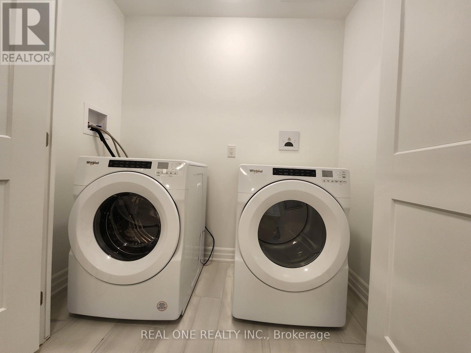 Two front load washing machines in a laundry room.