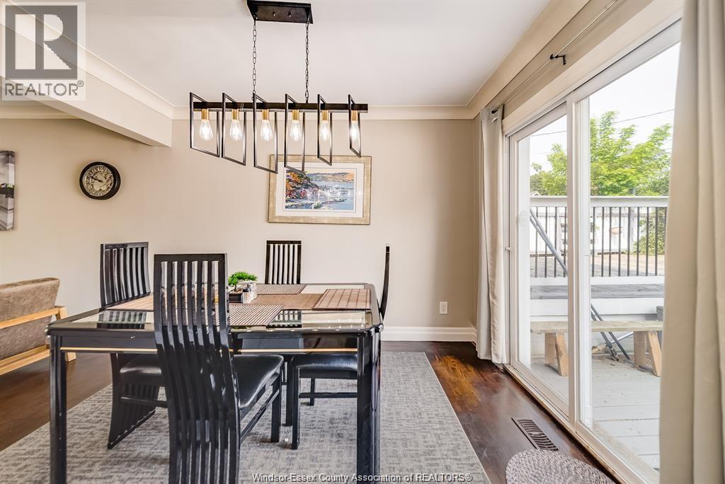 A dining room with a table and chairs.