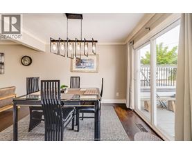 A dining room with a table and chairs.