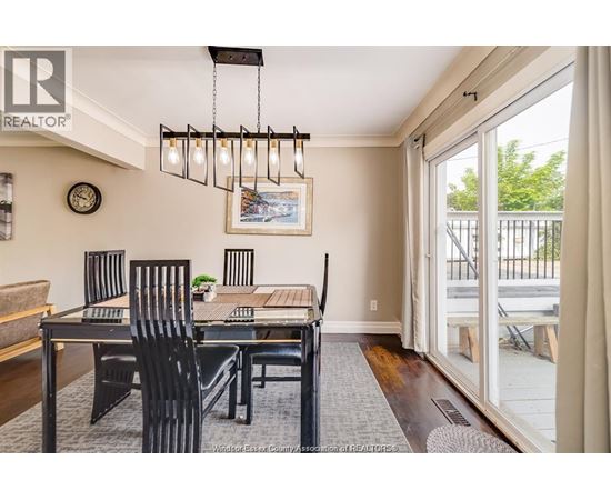 A dining room with a table and chairs.