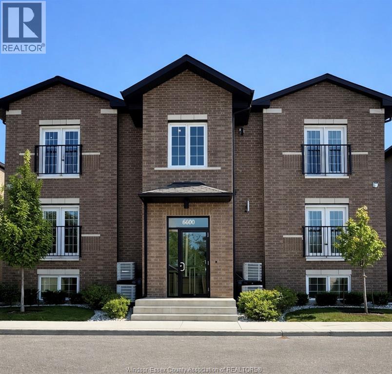A brick house with the number 6000 on the front door.