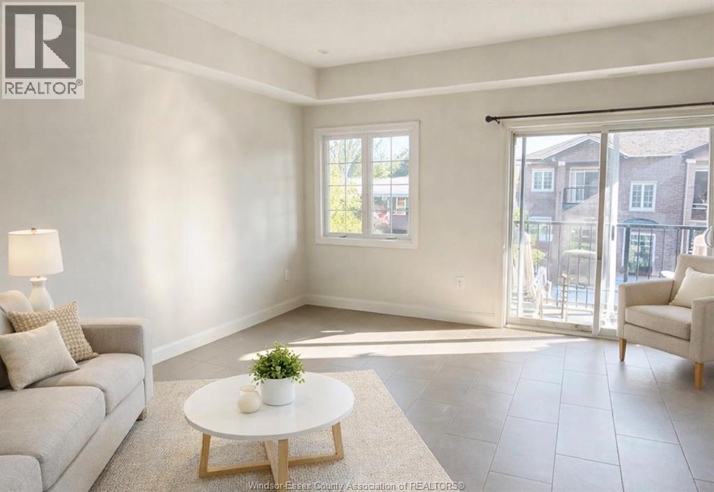 A living room with a grey couch, a white coffee table, and a sliding glass door.