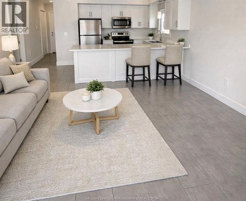 A modern kitchen with white cabinets and a breakfast bar.