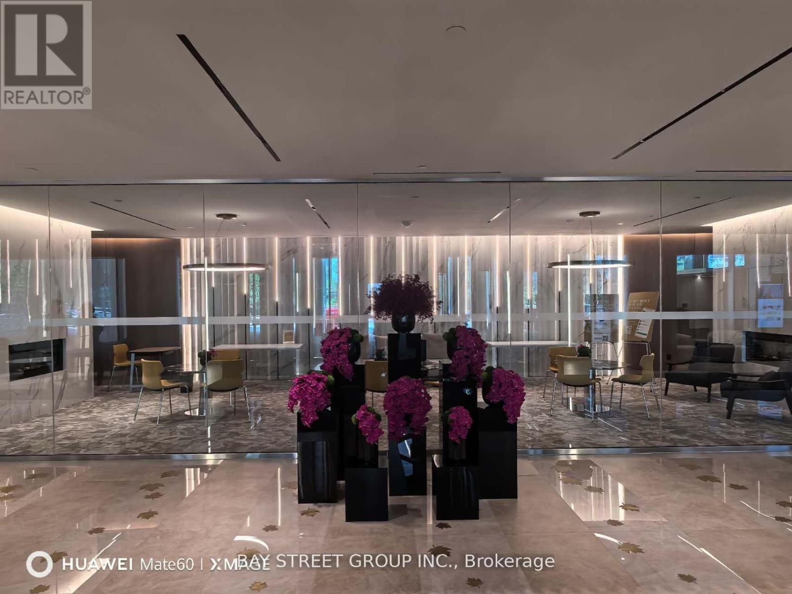 A modern office space with a glass wall and a reception desk.