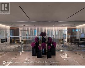 A modern office space with a glass wall and a reception desk.
