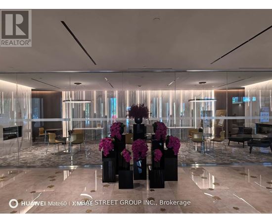A modern office space with a glass wall and a reception desk.
