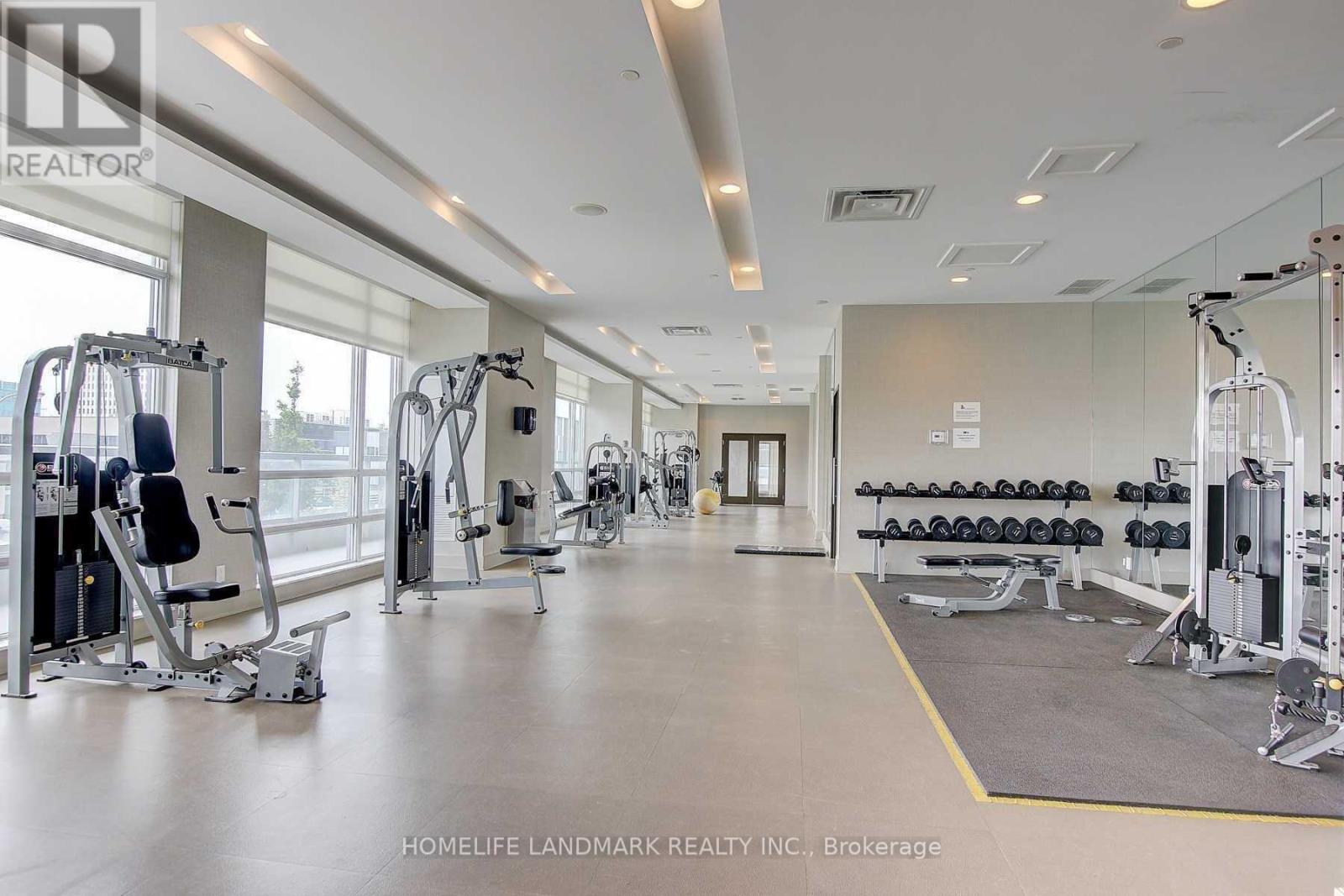 A gym with a variety of equipment including weights and cardio machines.