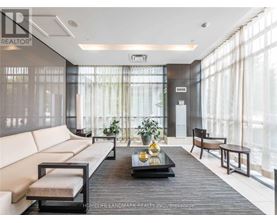 A modern living room with a large window and a wooden coffee table.