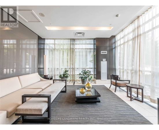 A modern living room with a large window and a wooden coffee table.