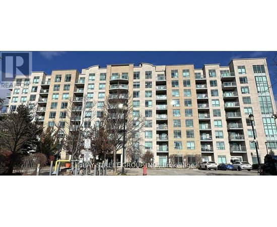 A large apartment building with a parking lot in front.