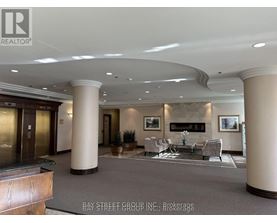 A spacious lobby with a fireplace and seating area.