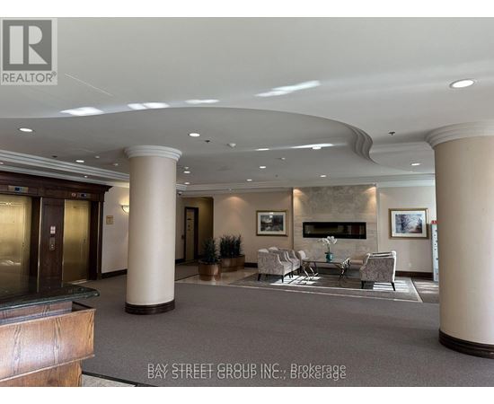 A spacious lobby with a fireplace and seating area.