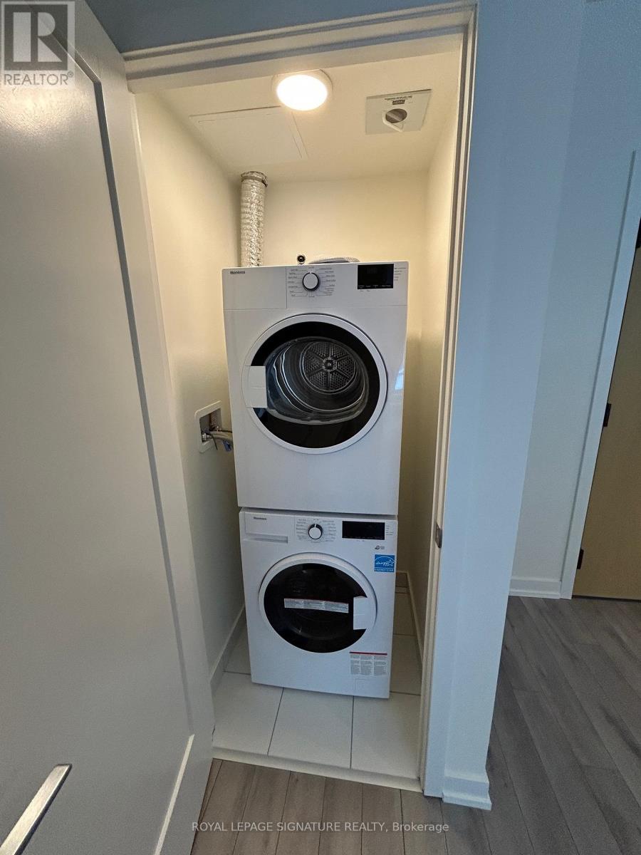 A white washing machine and dryer in a small laundry room.