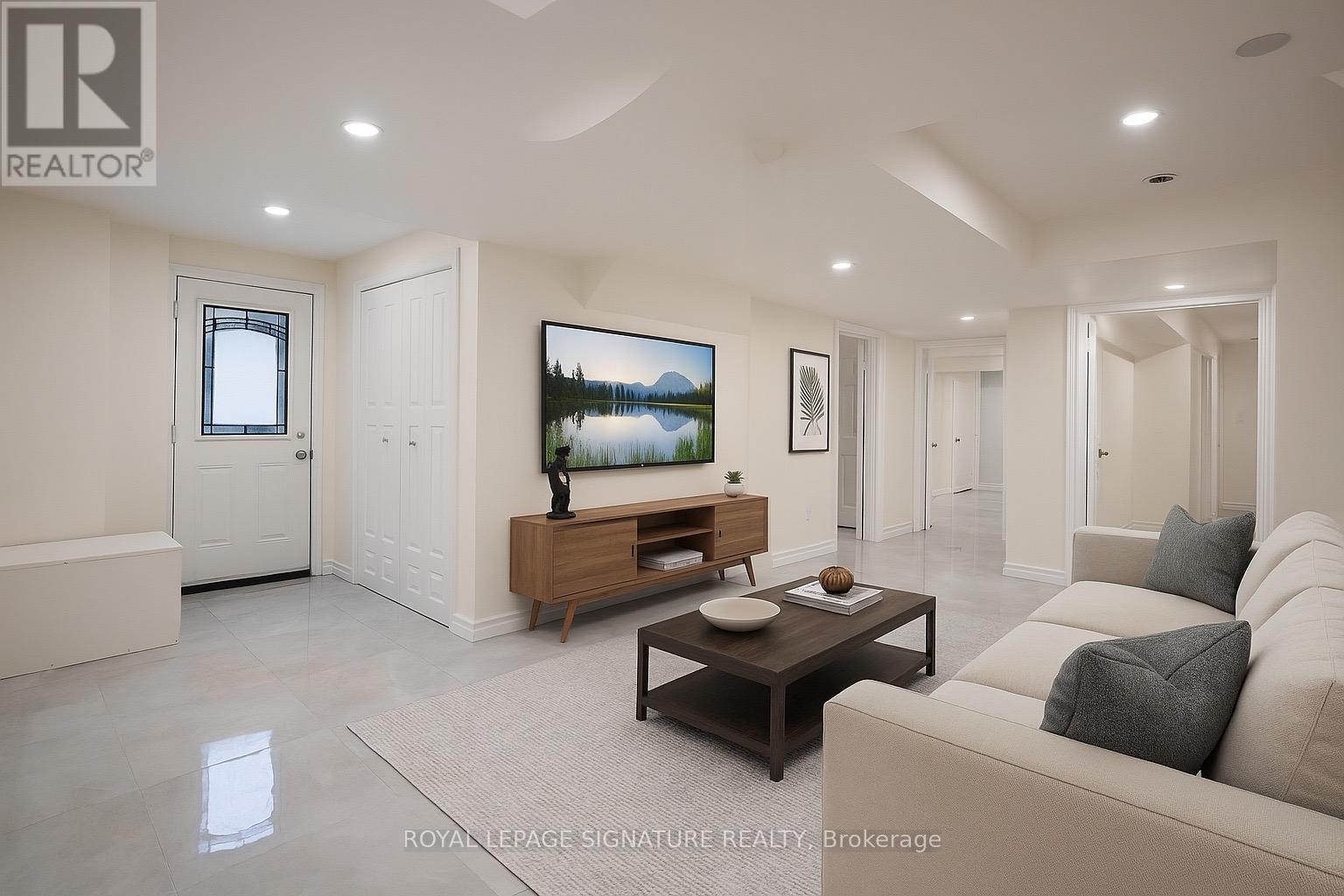 A living room with a flat screen TV and a coffee table.
