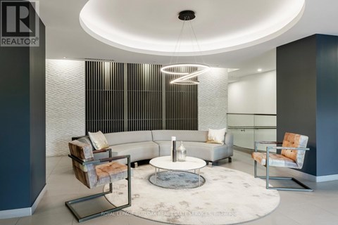 A modern living room with a circular coffee table in the center.