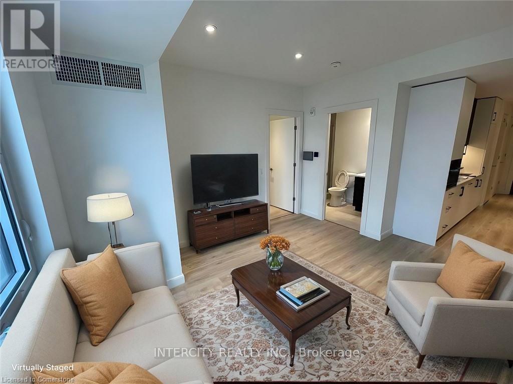 A living room with a couch, a coffee table, and a television.