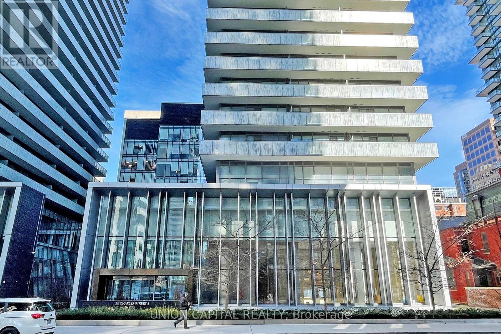 A modern building with a glass facade is the main focus of the image.