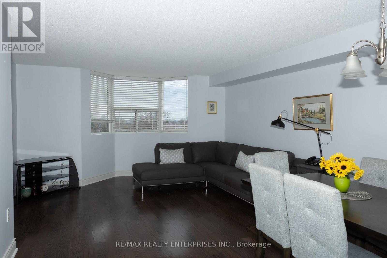 A living room with a grey couch and a black table.