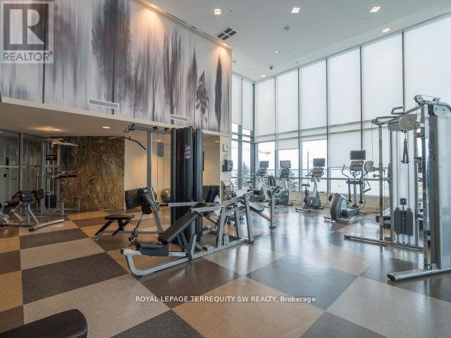 A gym with a variety of equipment including treadmills, weights, and exercise machines.