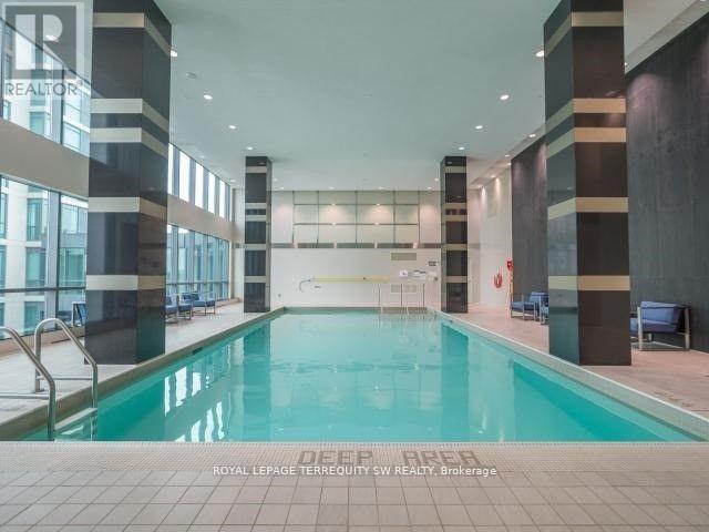 A large indoor swimming pool with a sign that says "DEEP BREAK" on the bottom.