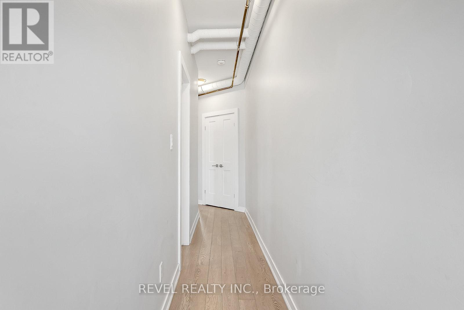 A long hallway with a door at the end.