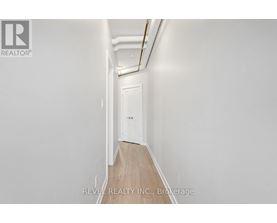 A long hallway with a door at the end.