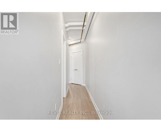 A long hallway with a door at the end.