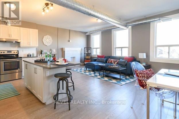 A kitchen with a bar stool and a countertop with a sink.