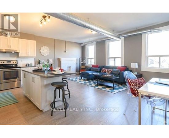 A kitchen with a bar stool and a countertop with a sink.