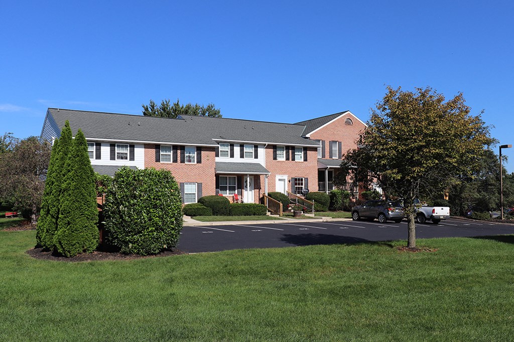 a large brick apartment building with a parking lot