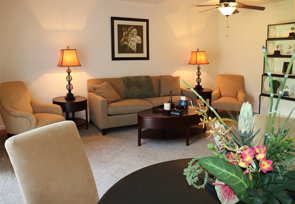 a living room with couches and chairs and a table
