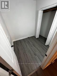 A room with a wooden floor and white walls.