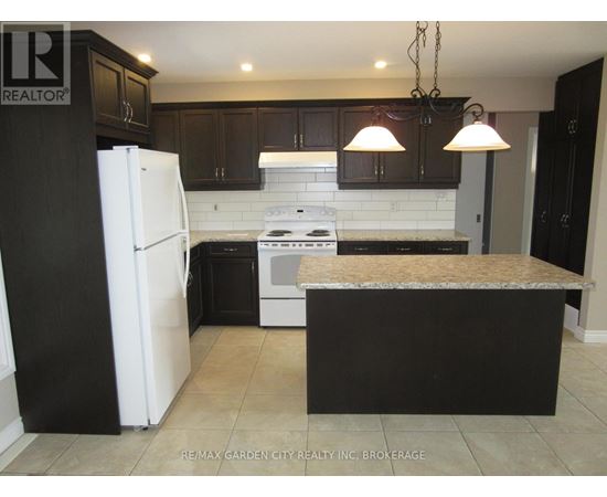 A spacious room with a large window and tiled floor.