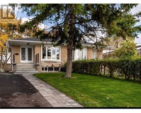 A house with a front yard and a tree in front of it.
