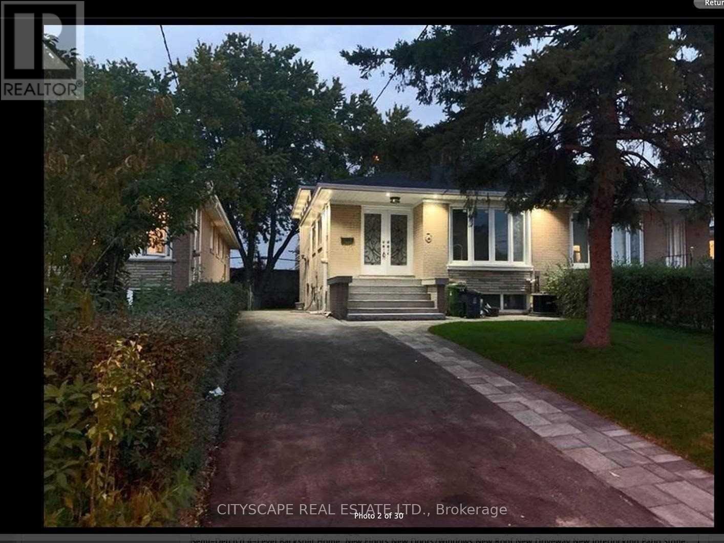 A house is shown with a driveway in front of it.
