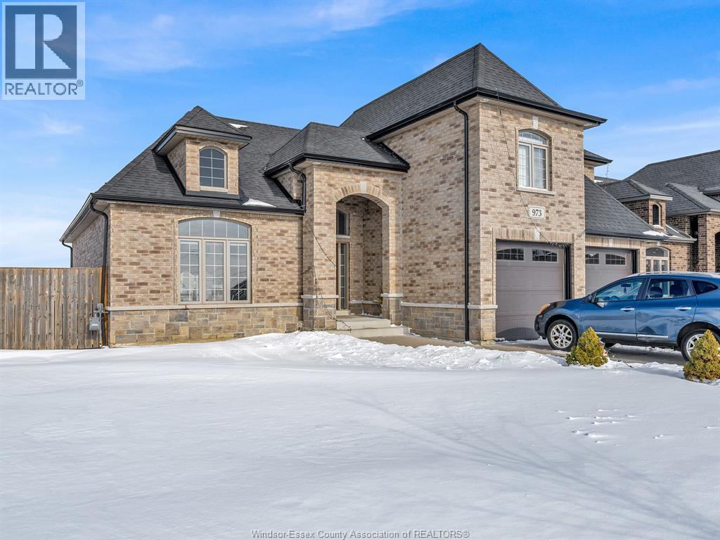 A large house with a car parked in front of it.